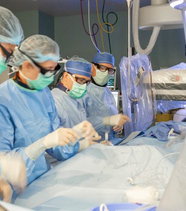 Biplane digital subtraction angiography DSA catheterization suite with neuro-interventional team